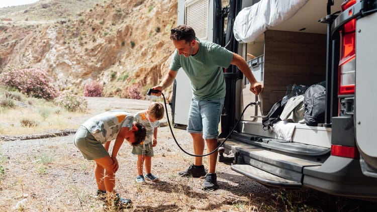 father-and-children-cooling-down-by-camper-van and rv plumbing